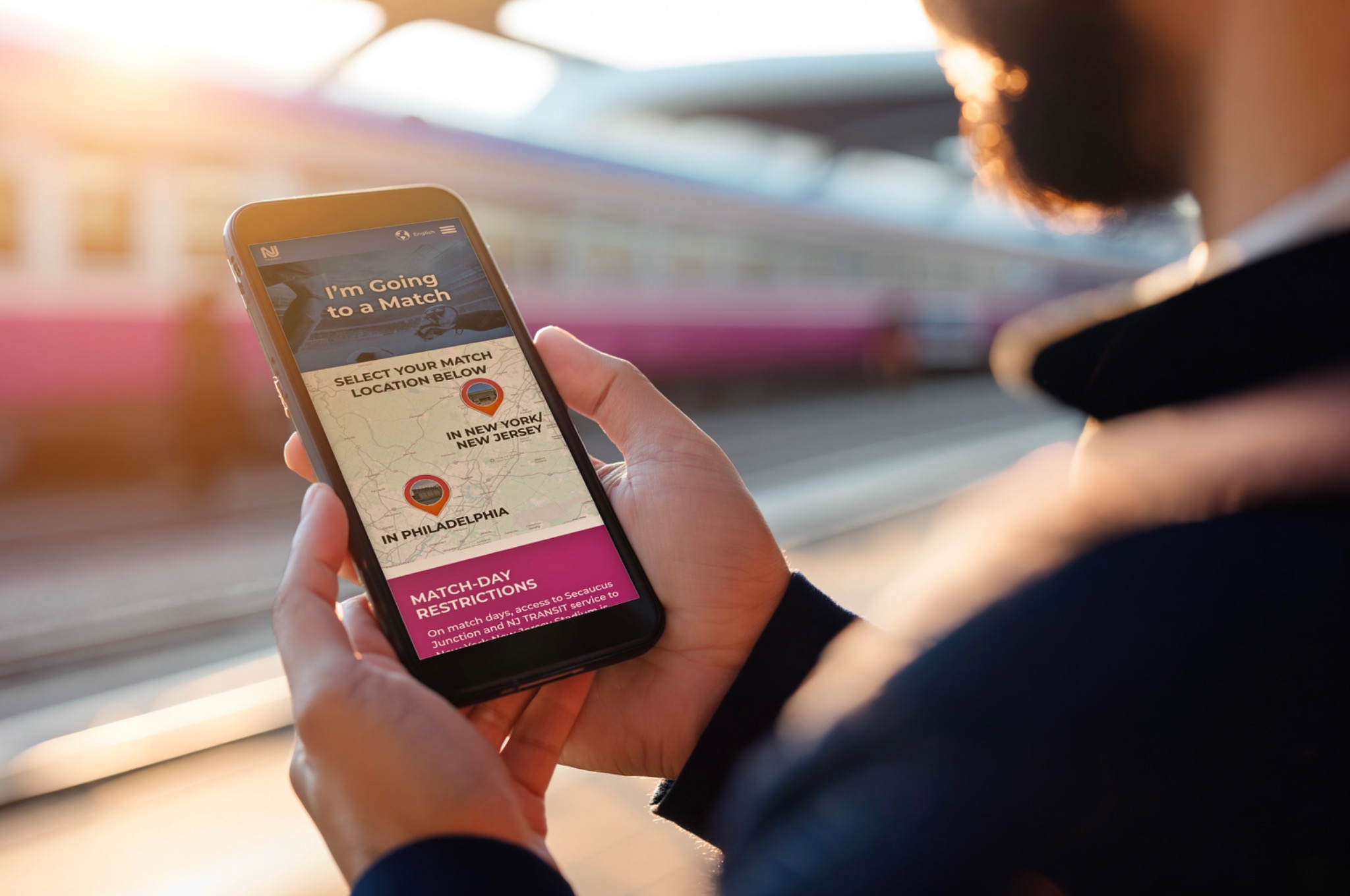 Traveler using the NJ TRANSIT World Cup site at a train platform